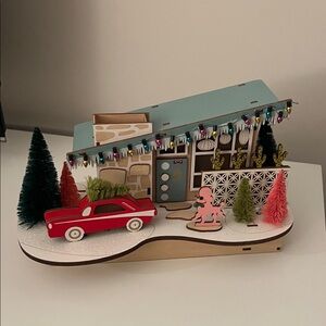 Retro Holiday Scene with Red Car and Christmas Trees